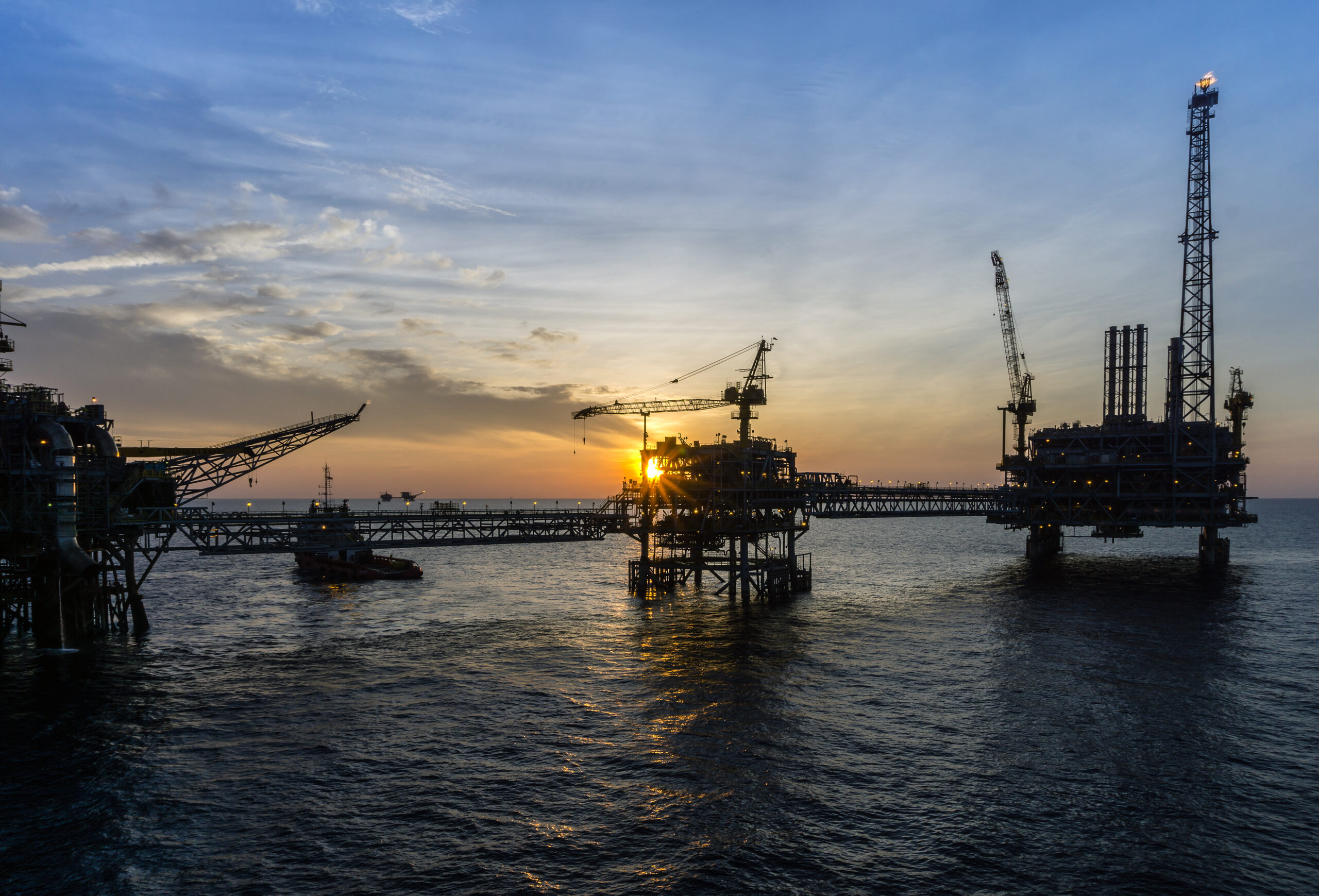 silhouette-cranes-commercial-dock-against-sky-sunset